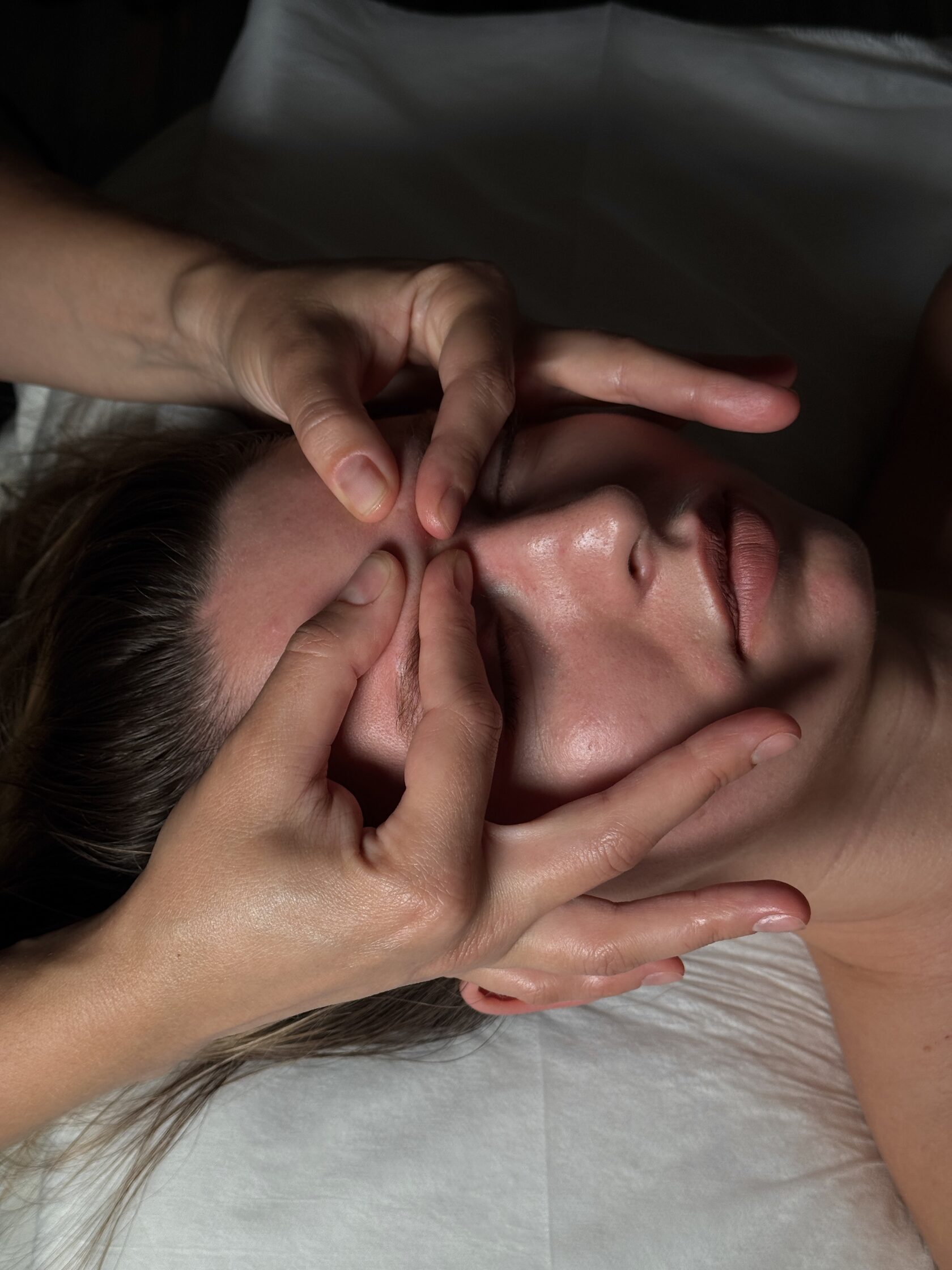 Face Bliss facial massage technique demonstrated on a model
